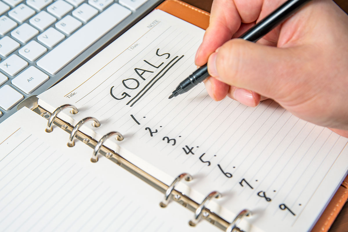 business man writing down goals